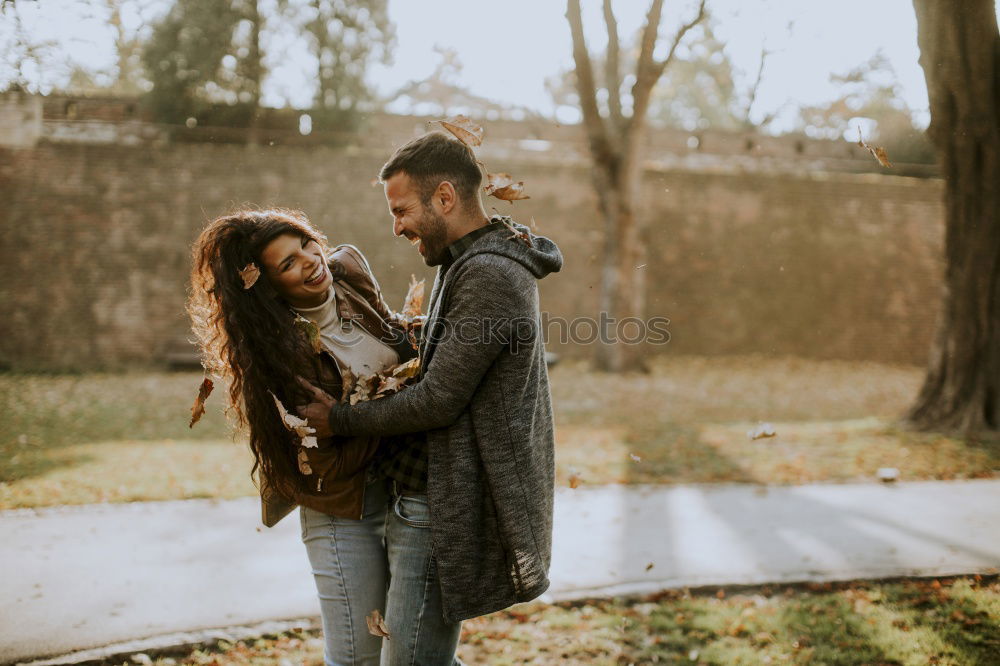 Similar – Young couple embracing under umbrella in a rainy day