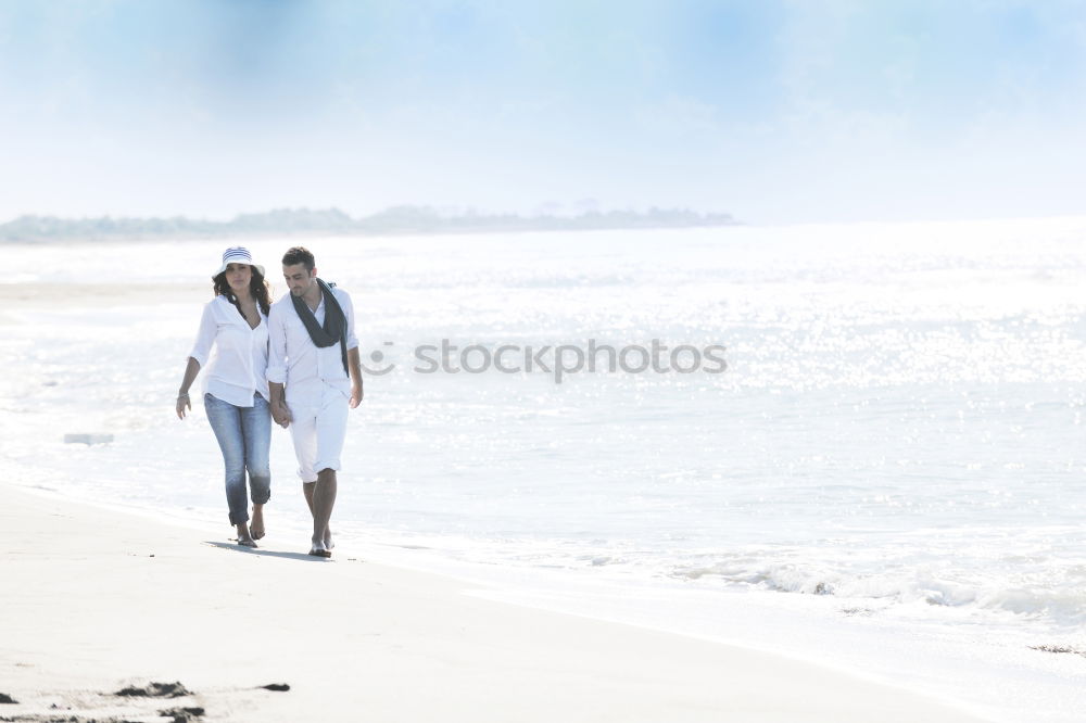 Image, Stock Photo Romantic bride and groom strolling on beach