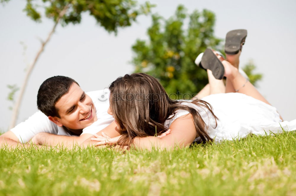 Similar – Happy smiling couple laying on green grass