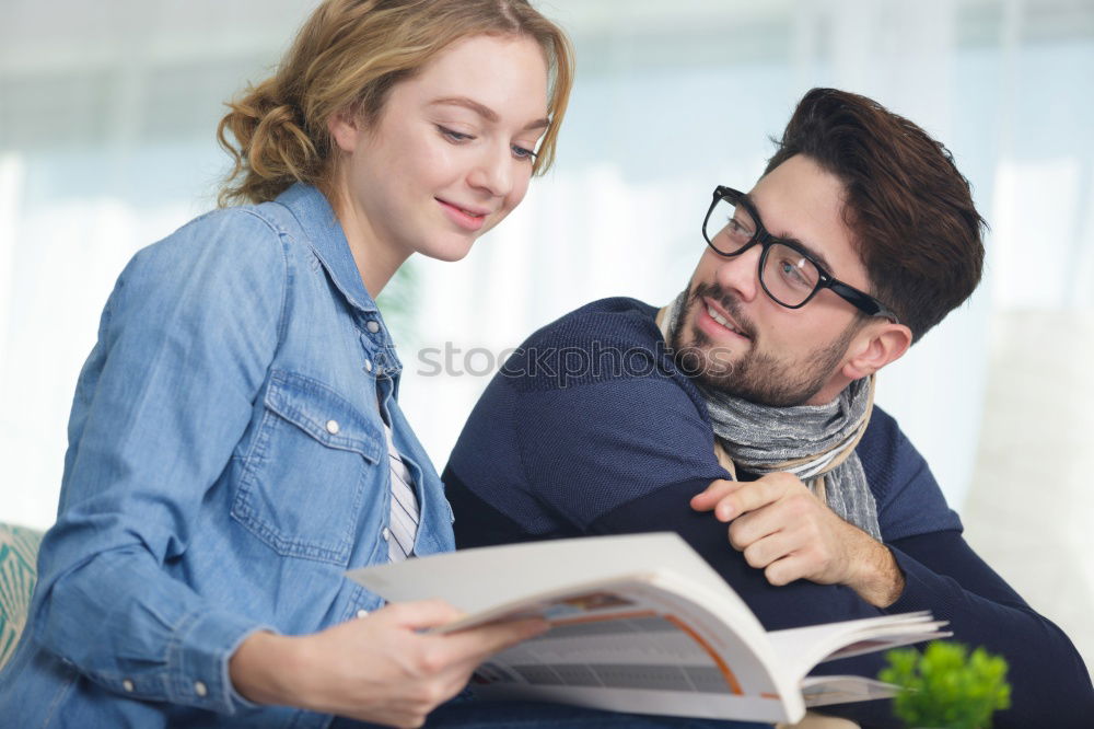 Similar – Image, Stock Photo Young couple reading book on couch at home