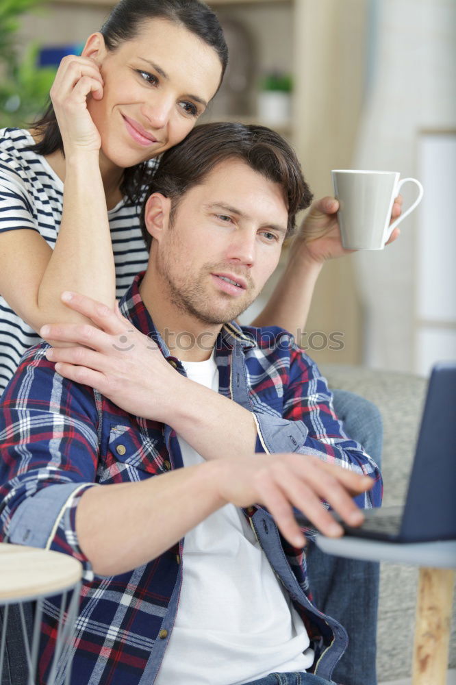 Image, Stock Photo Young couple reading book on couch at home