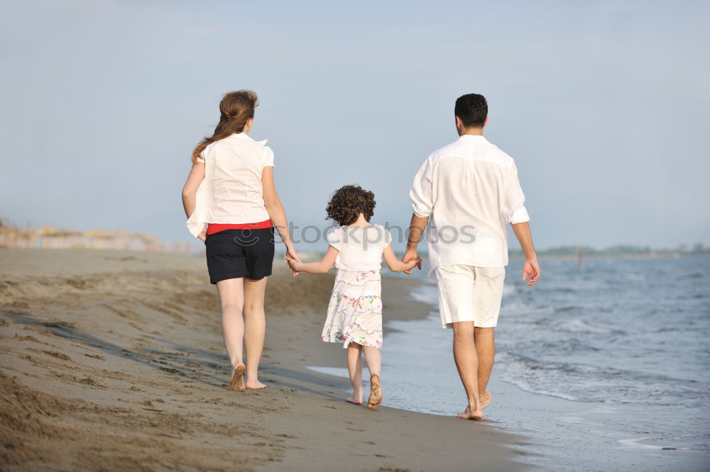 Similar – Image, Stock Photo Happy family walking on the beach at the day time. Concept of friendly family.