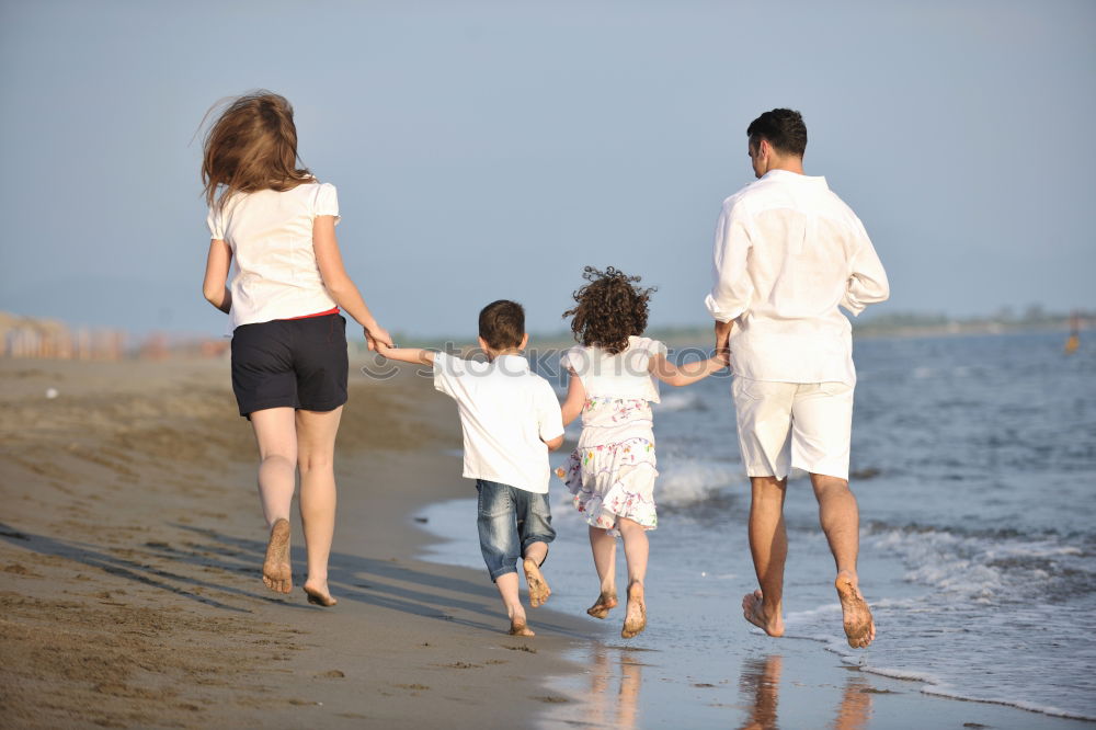 Image, Stock Photo Happy family walking on the beach at the day time. Concept of friendly family.