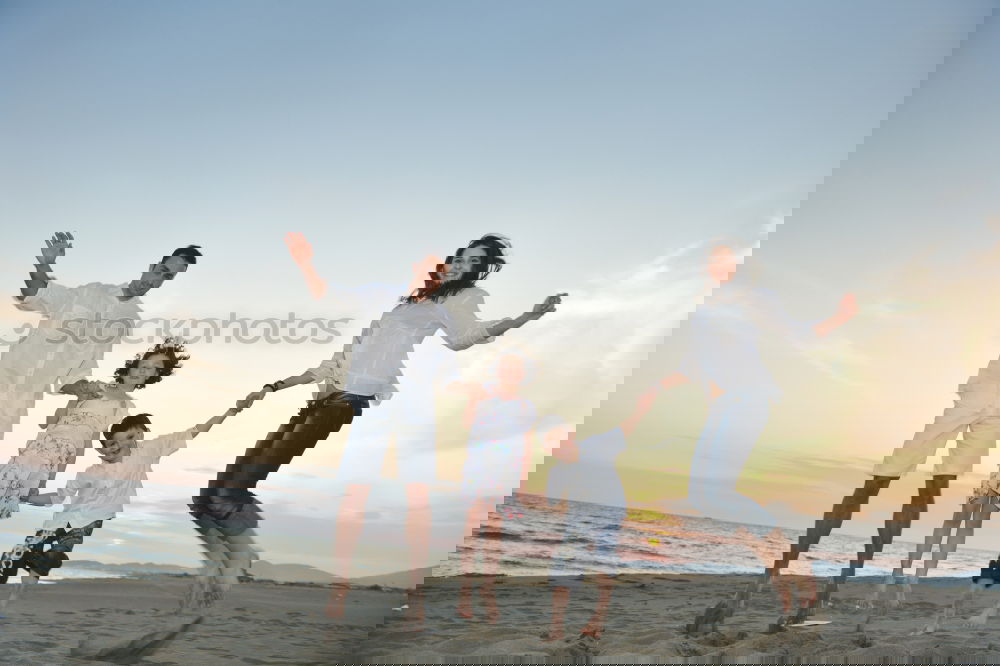 Similar – Image, Stock Photo Happy family walking on the beach at the day time.