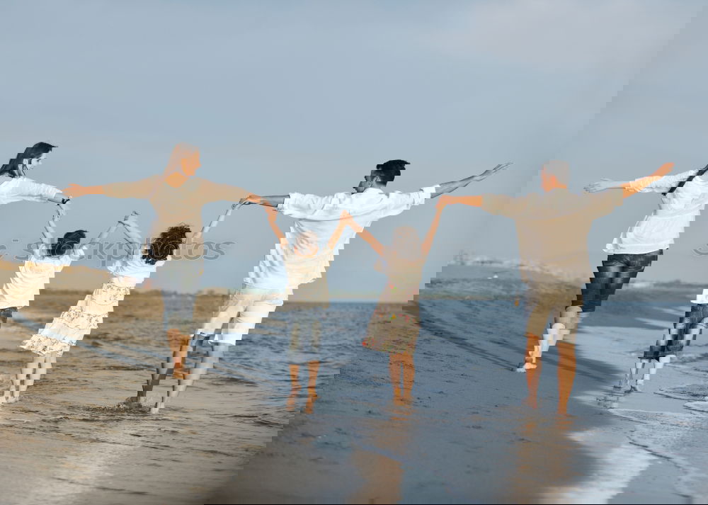 Similar – Image, Stock Photo Mother and children playing on the beach.