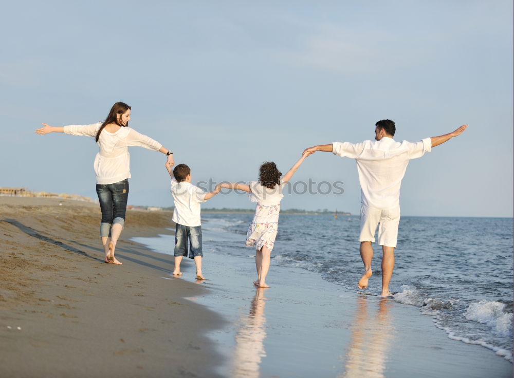 Similar – Father and daughter playing on the beach at the day time.