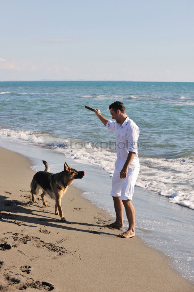 Similar – Image, Stock Photo young male playing with dog on beach during sunrise