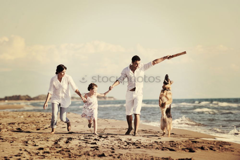 Similar – Happy family standing on the beach at the day time. People having fun outdoors. Concept of summer vacation and friendly family.