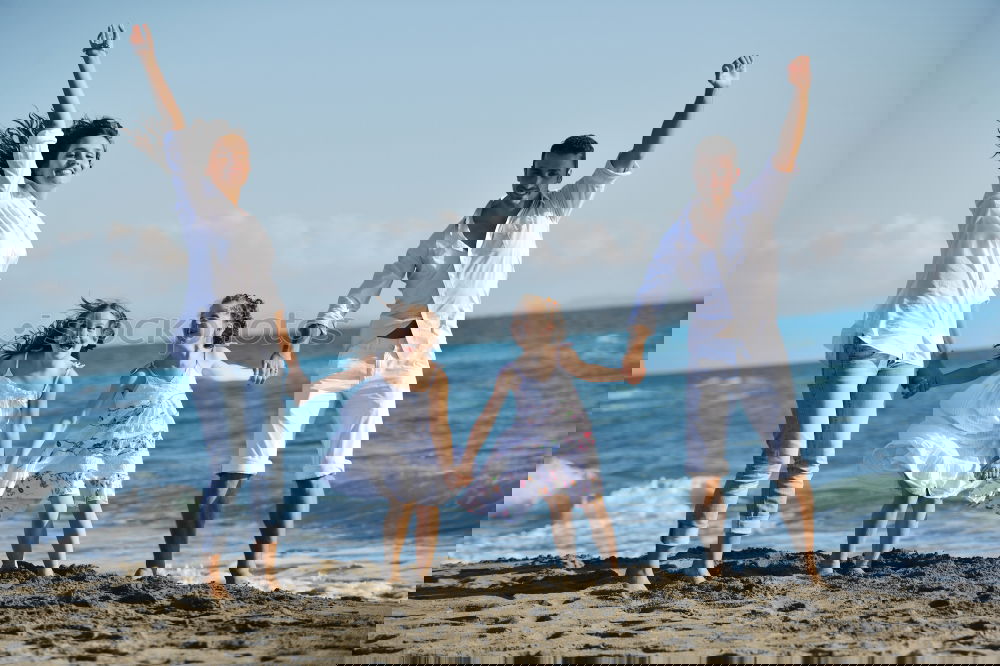 Similar – Image, Stock Photo Happy family walking on the beach at the day time.