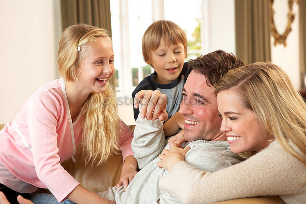 Happy family in a urban park playing with tablet computer