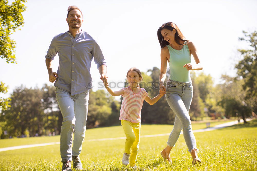 Similar – happy family of four hand in hand on the field