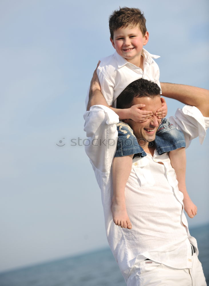 Similar – Image, Stock Photo Father and son playing superhero on the beach at the day time. People having fun outdoors. Concept of summer vacation and friendly family.