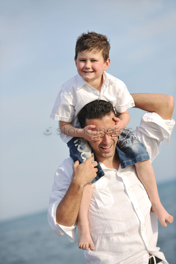 Similar – Image, Stock Photo Father and son playing superhero on the beach at the day time. People having fun outdoors. Concept of summer vacation and friendly family.