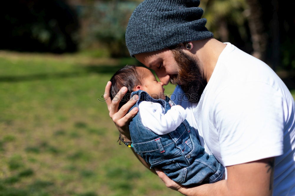Similar – Image, Stock Photo Couple embracing and looking to their newborn over dark background
