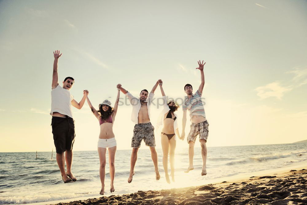 Similar – Happy family standing on the beach at the day time. People having fun outdoors. Concept of summer vacation and friendly family.