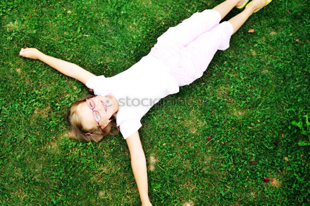 Similar – Excited girl in headphones on grass