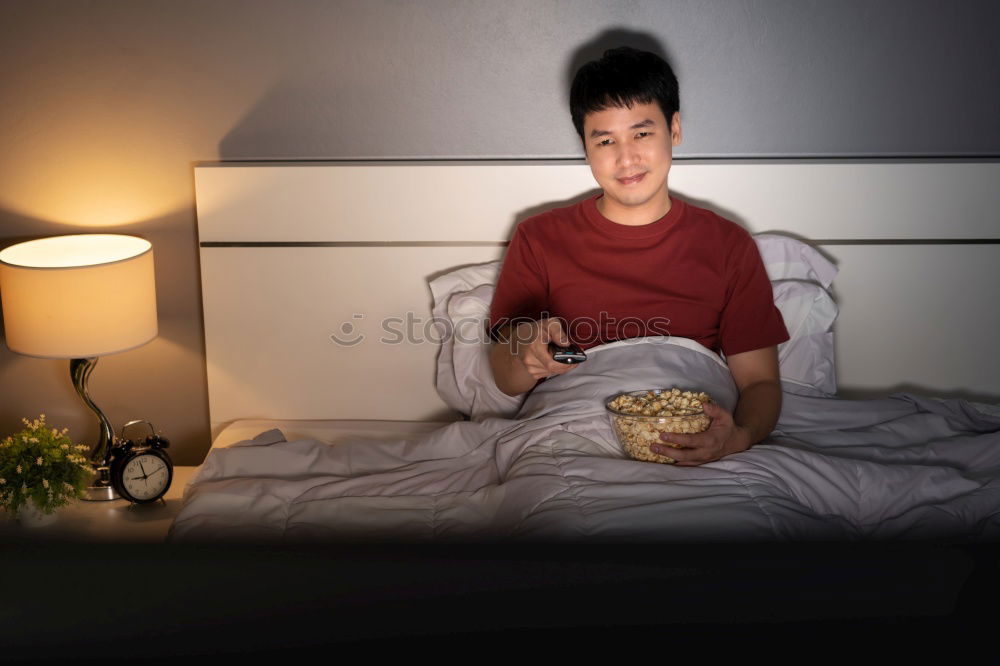 Similar – Relaxed boy holding smartphone sitting in chair at home