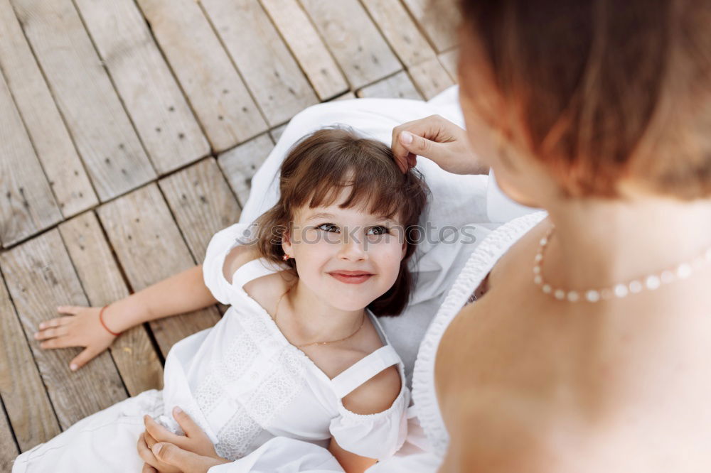 Similar – happy child girl sitting on bed and hugs pillow