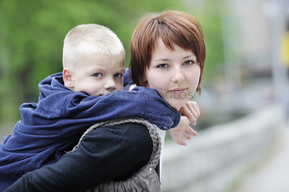 Similar – Mother and son looking through a train window as they enjoy a days travel with the small boys face reflected in the glass