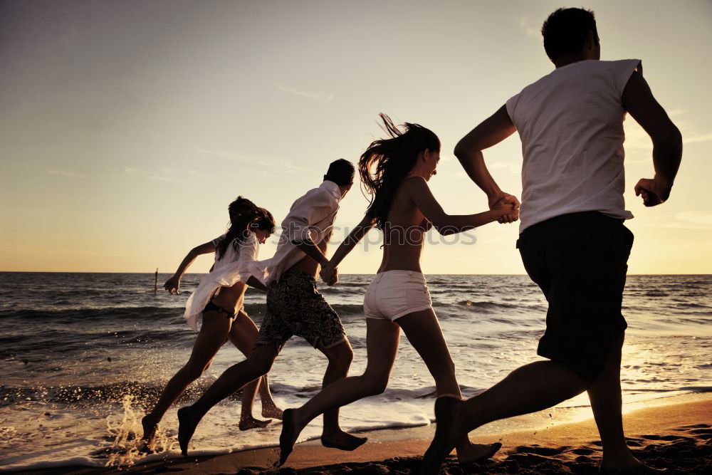 Similar – Happy family standing on the beach at the day time. People having fun outdoors. Concept of summer vacation and friendly family.