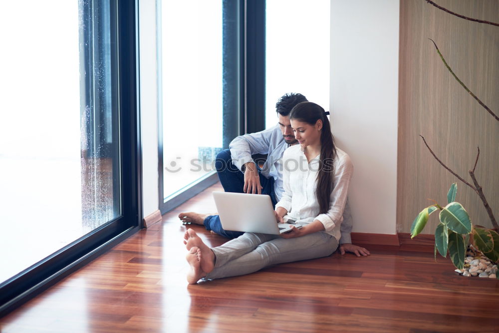 Mature woman sitting on couch at modern home