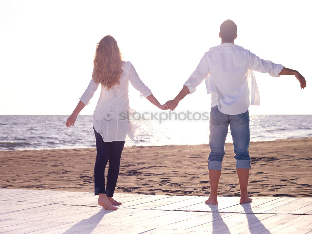 Similar – Brothers sitting at waterfront.Back view