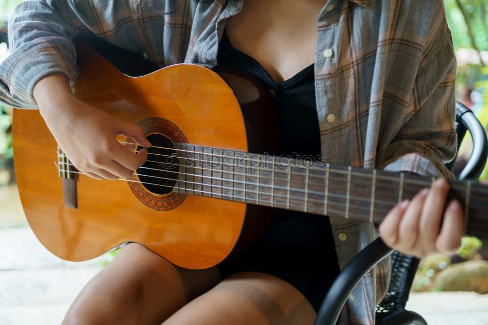 Similar – Mädchen spielt Ukulele im Gartenstuhl