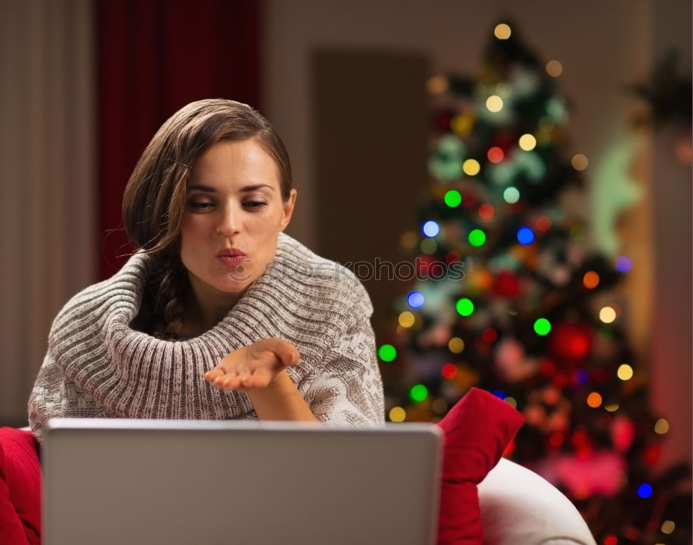 A happy couple with a child is celebrating Christmas with their friends on video call using webcam. Family greeting their relatives on Christmas eve online. New normal