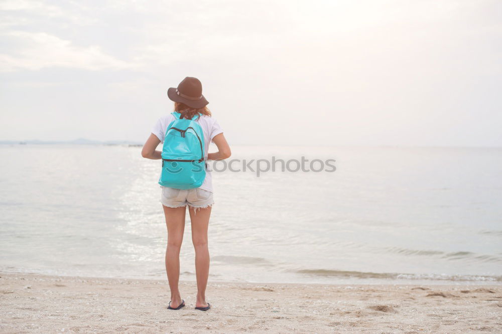 Similar – Asian woman standing on the terrace and looking around the sea.