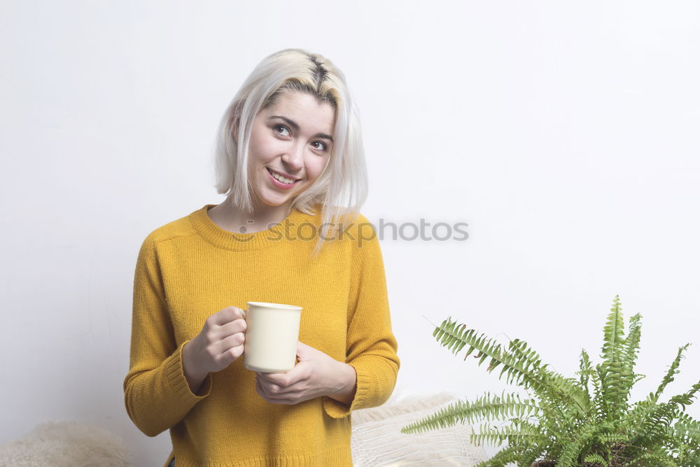 Similar – Happy young woman holding a cup of tea or coffee