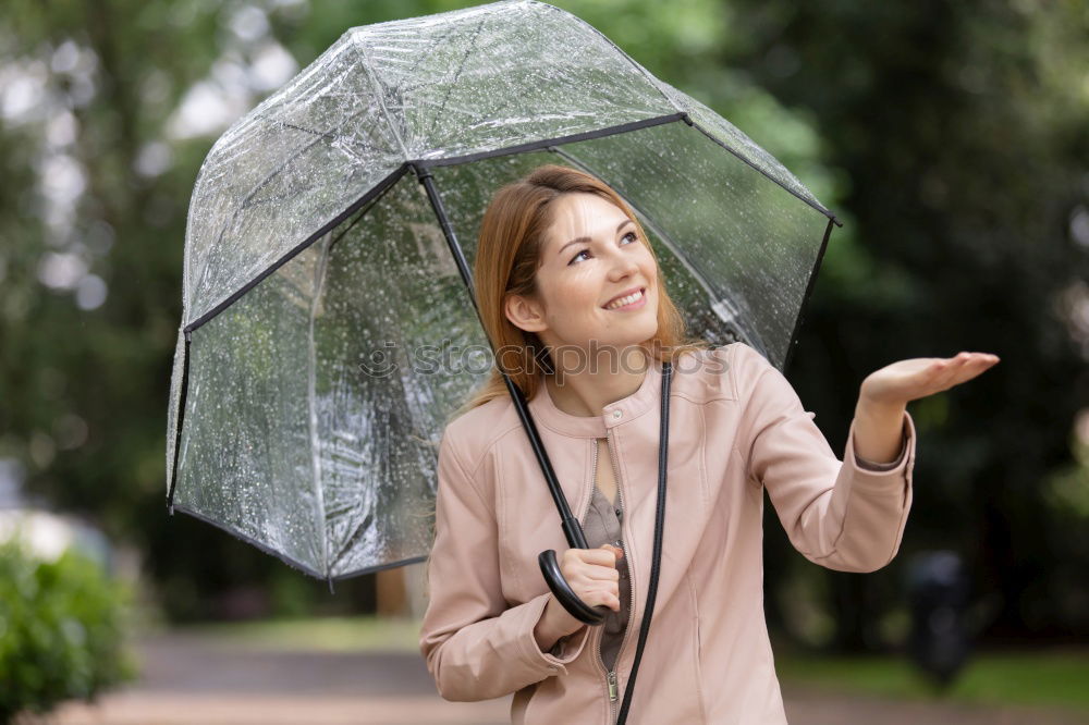 Similar – Woman with umbrella in front of green wall