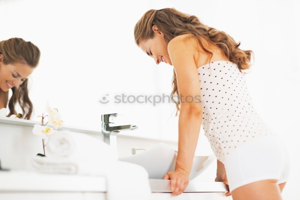 Similar – Young female adult brushing teeth in the morning