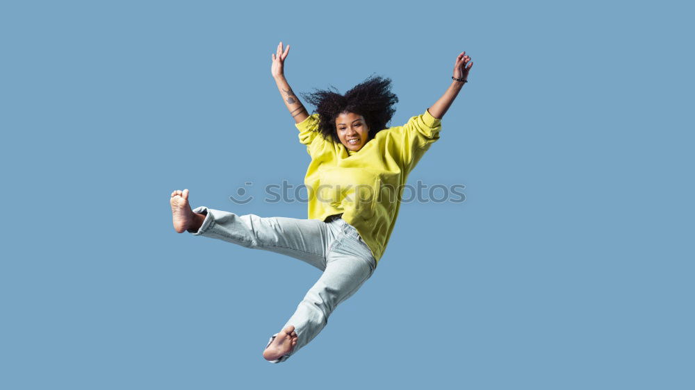 Similar – Young girl in jumpsuit with flower pattern jumps to the left in front of blue sky