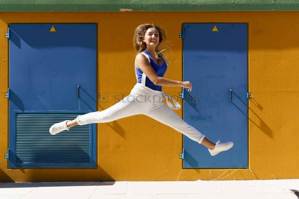 Stylish girl flying above ground