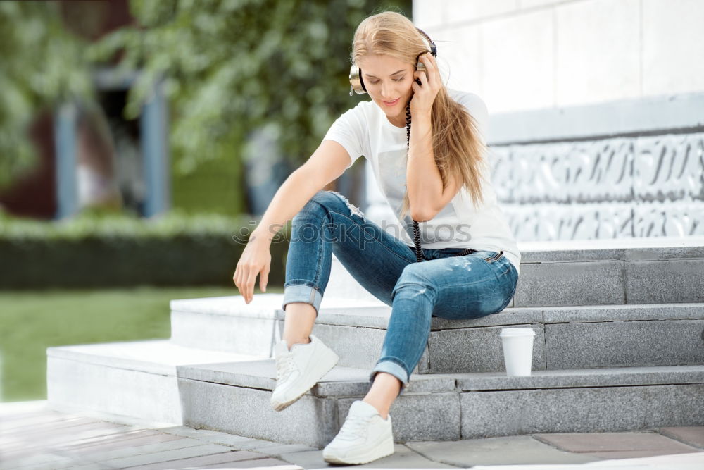 Similar – Woman sitting outdoors putting her hand near the camera.