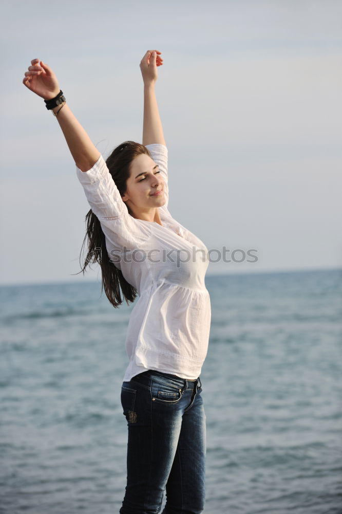 Similar – Young woman at the beach while the sunset smiling