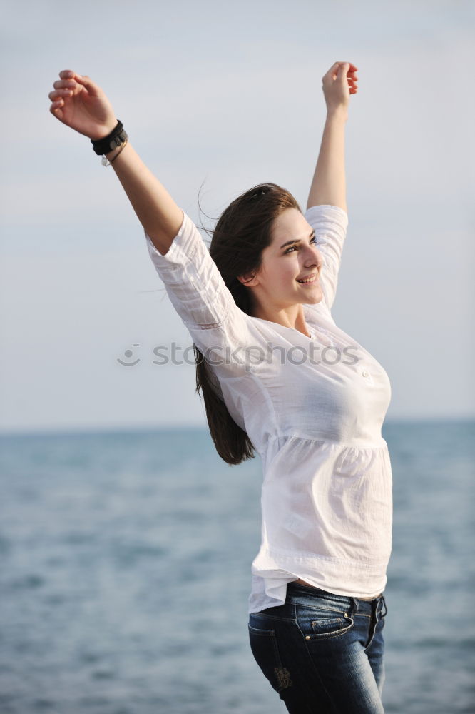 Similar – young woman jumps for joy with outstretched arms towards the sky