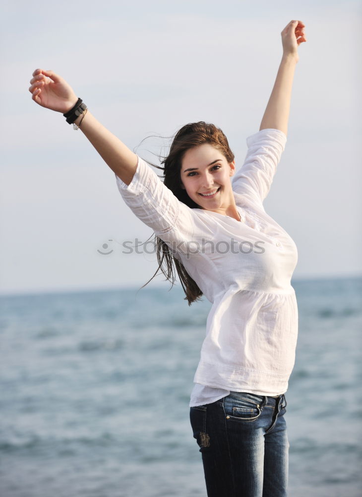 Similar – Young woman at the beach while the sunset smiling