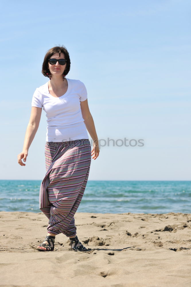 Similar – Image, Stock Photo Woman walking away on the idylic beach.