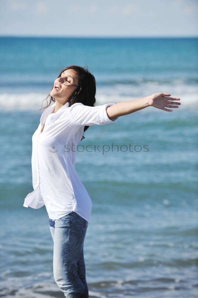 One happy little girl playing on the beach at the day time.