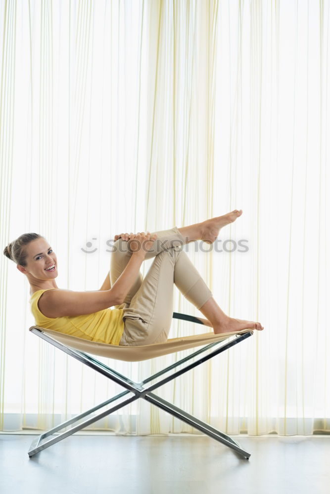 Similar – Image, Stock Photo Feet up. Casual young woman sits barefoot on a comfortable armchair, relaxes, raises her legs. vertical.