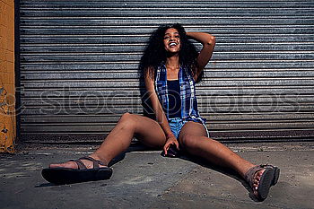 Similar – Young, slim, athletic woman in hot pants stands barefoot in front of a wooden door of a water tower