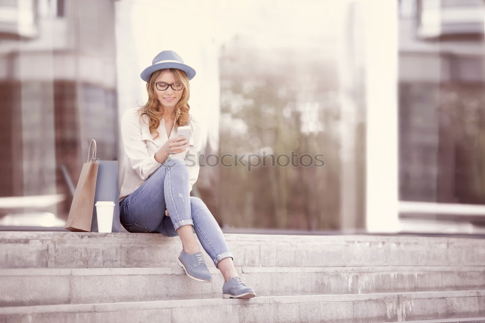 Similar – Young woman sitting on the street