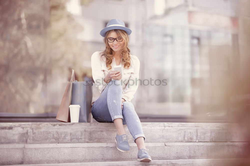 Similar – Young woman sitting on the street