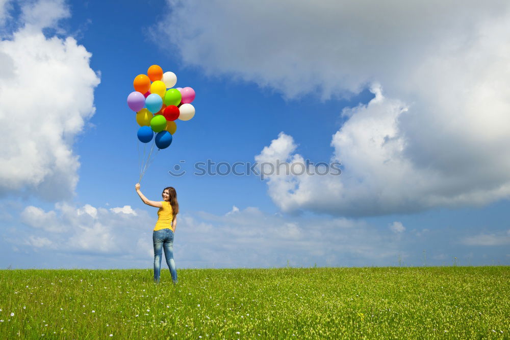 Similar – Father and daughter with balloons playing on the beach