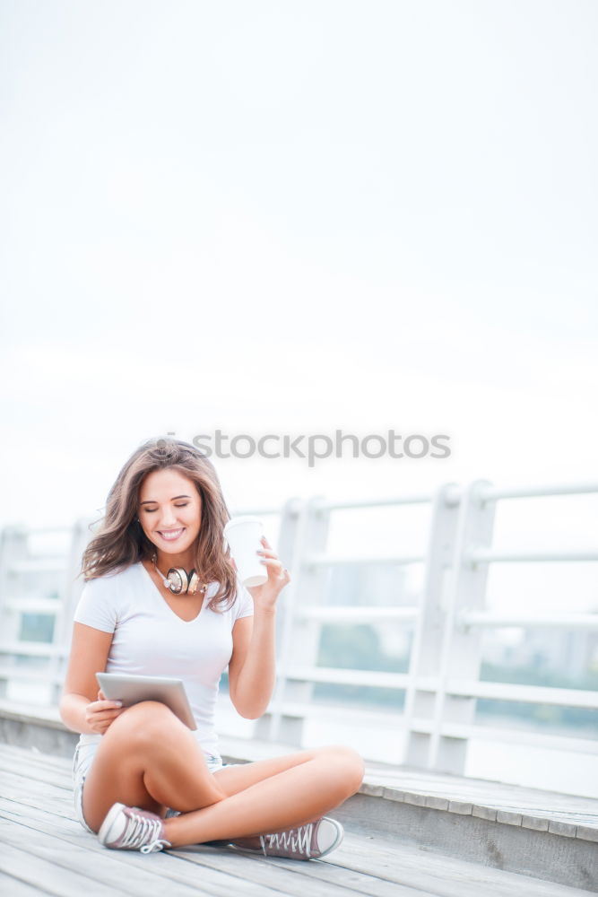 Similar – Brunette woman leaning on handrail at river