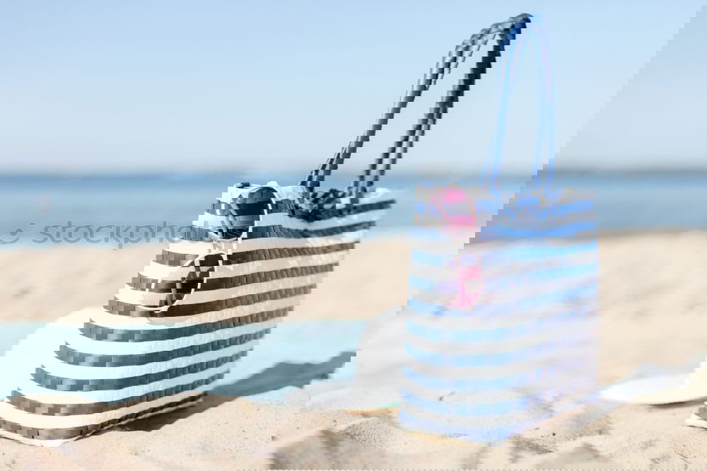 Similar – Image, Stock Photo Several beach accessories, bag, hat and color towel put on the sand close to the sea water