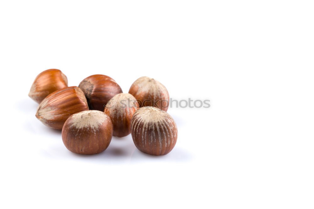 Similar – Image, Stock Photo Hazelnuts on a wooden table in a row