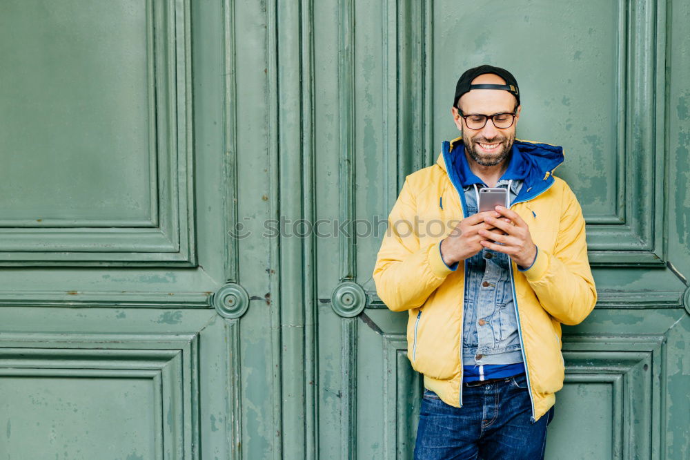 Similar – Man with cup and phone at window