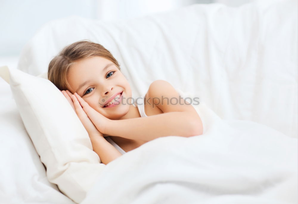 cute happy toddler girl on bed